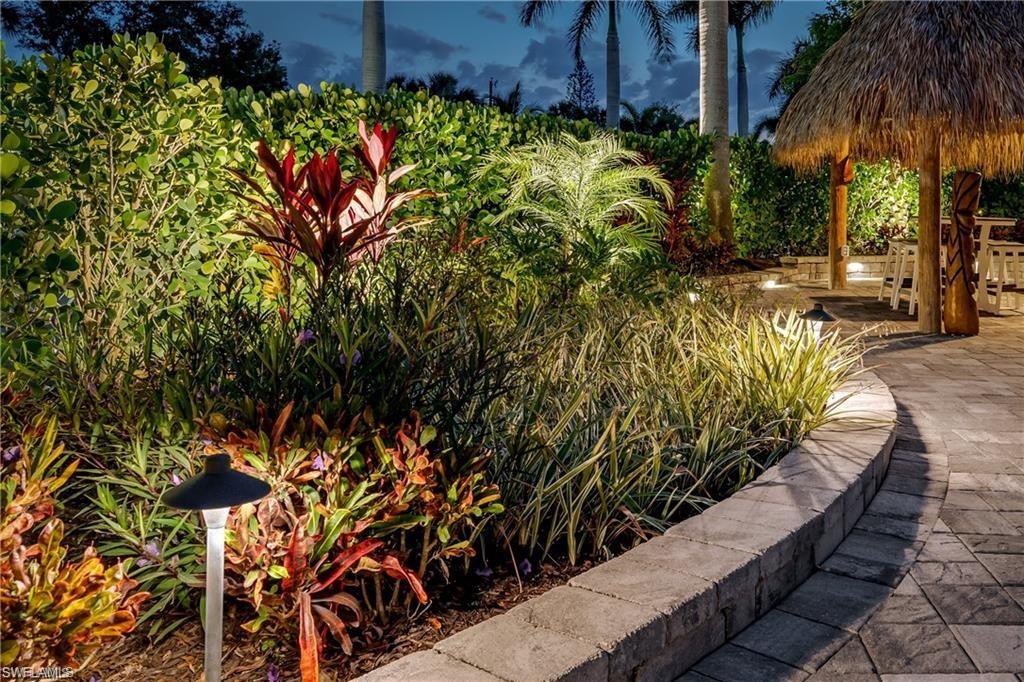 13526 Snook Circle Naples, FL 34114 - Photo 23 of 36 a view of a garden with a flower garden