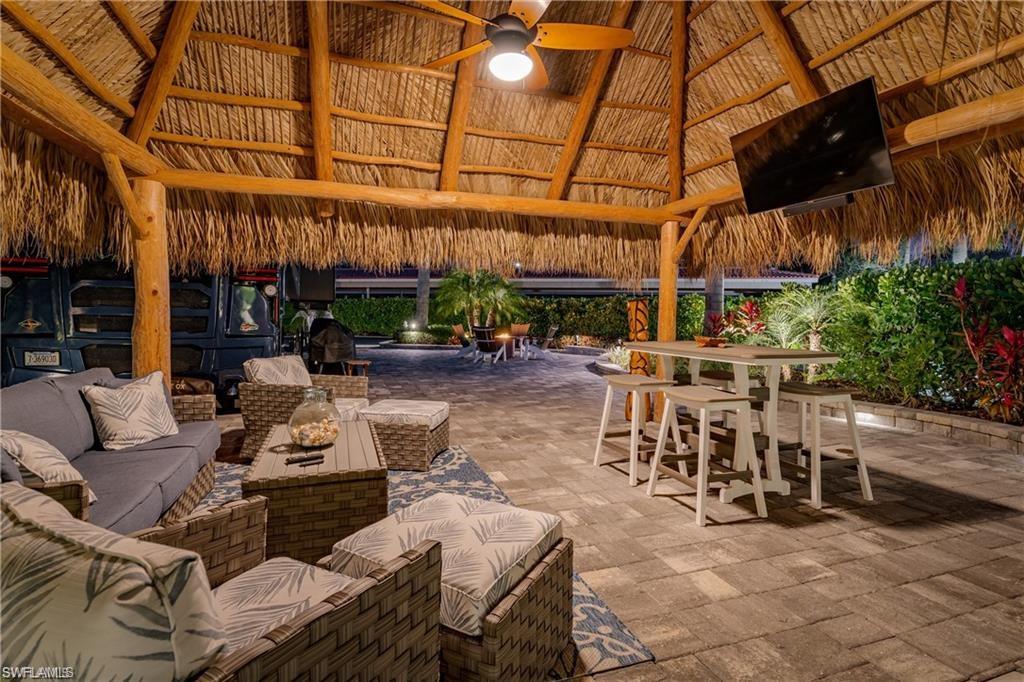 13526 Snook Circle Naples, FL 34114 - Photo 28 of 36 a view of a patio with dining table and chairs