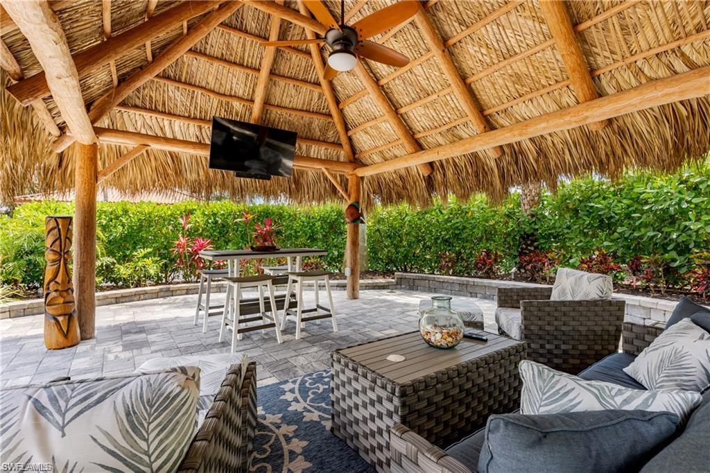 13526 Snook Circle Naples, FL 34114 - Photo 8 of 36 a view of a patio with couches table and chairs and potted plants