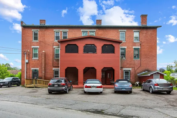 a view of a car parked in front of a brick house