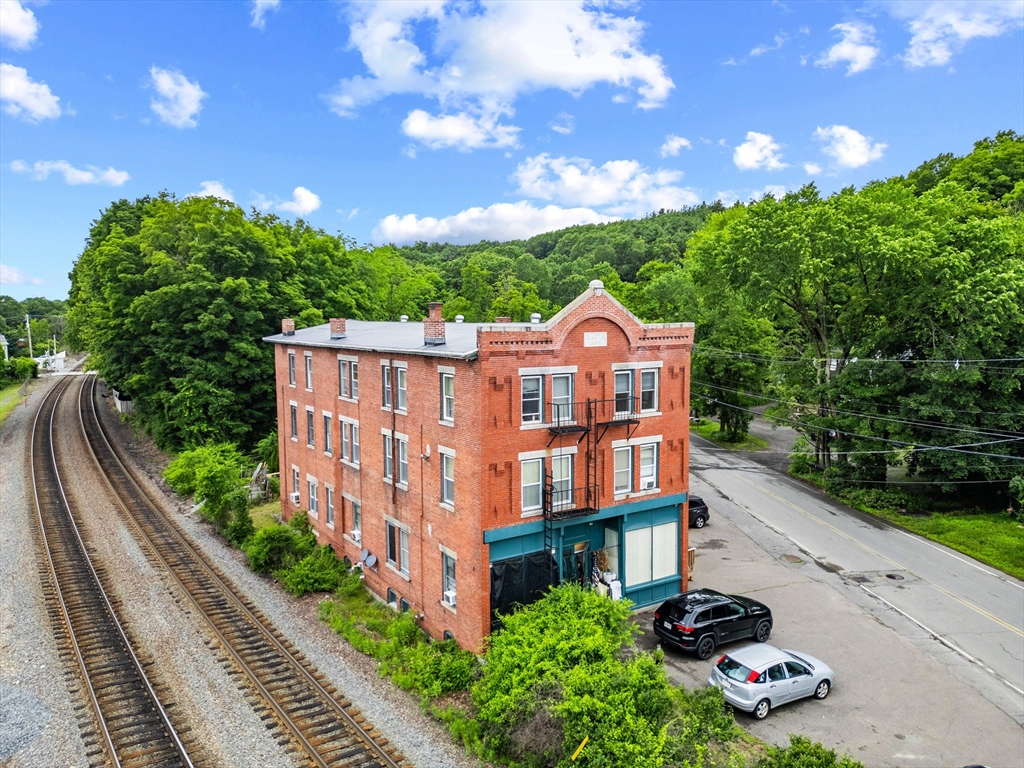 4 Davis Street Shirley, MA 01464 - Photo 7 of 18 a view of a street with a lot of flower plants in front of it
