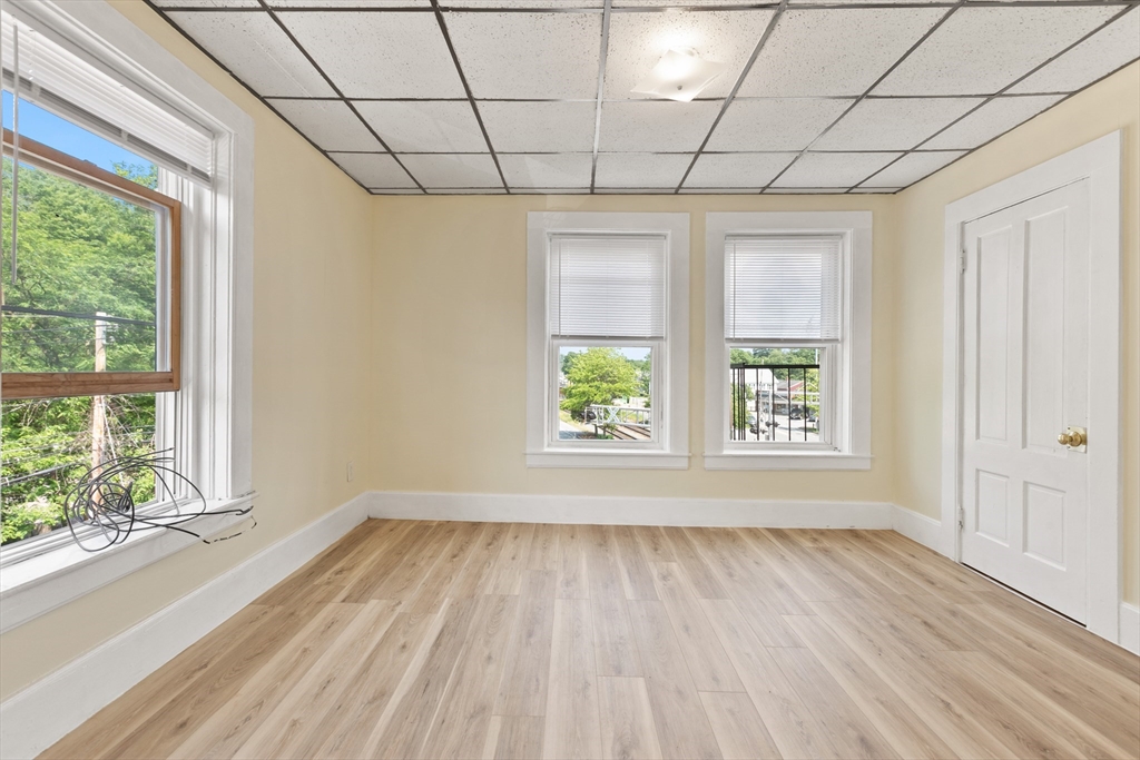 4 Davis Street Shirley, MA 01464 - Photo 9 of 18 an empty room with wooden floor and windows