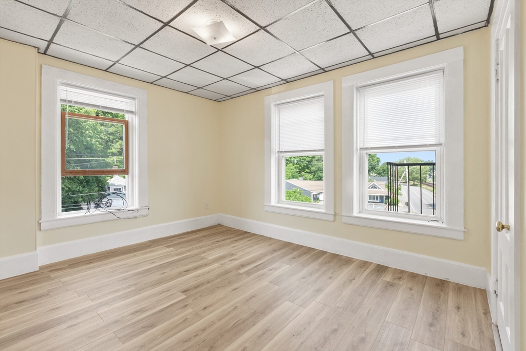4 Davis Street Shirley, MA 01464 - Photo 10 of 18 an empty room with wooden floor and windows