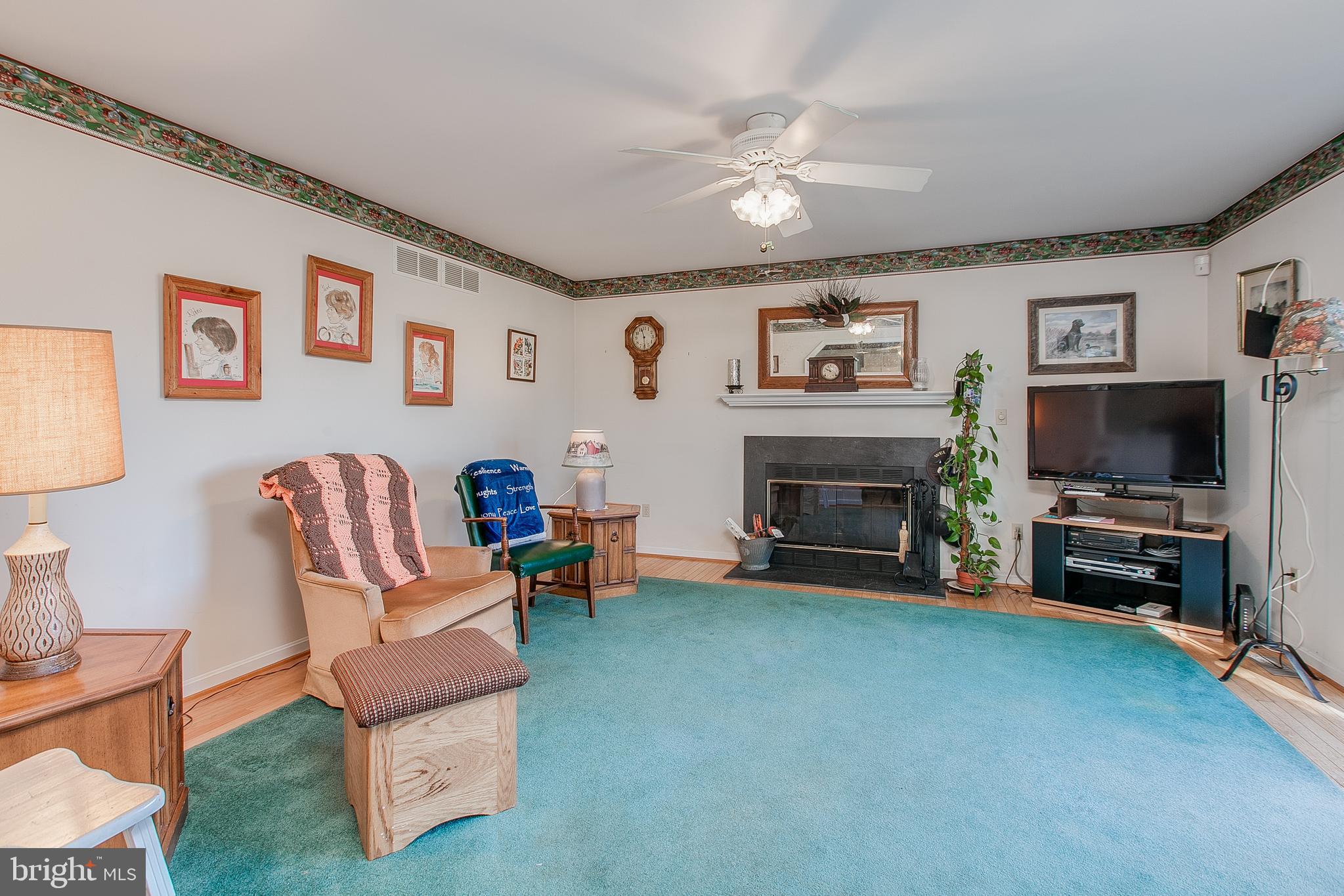 890 4 Seasons Road Westminster, MD 21157 - Photo 16 of 49 Family room with HW floors and fireplace