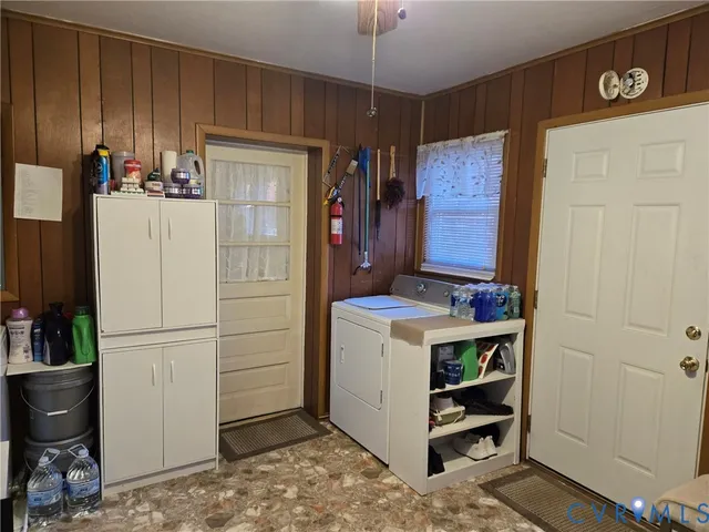 a view of kitchen with refrigerator and cabinets
