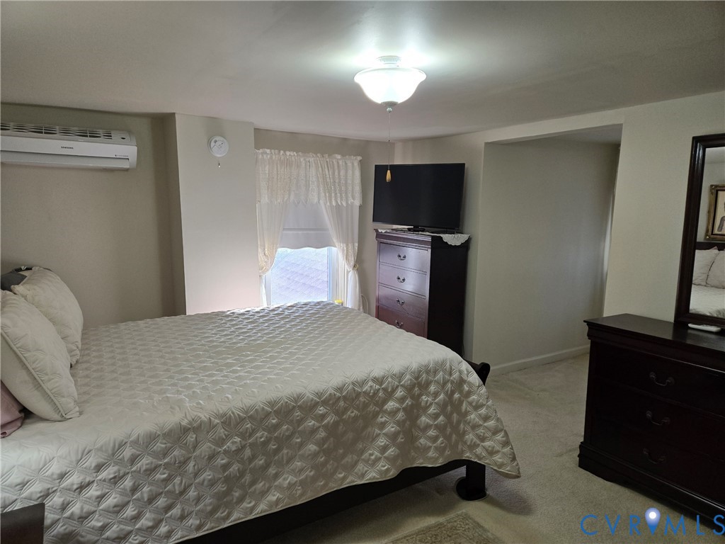 6883 Flat Rock Road Warfield, VA 23889 - Photo 14 of 25 a bedroom with a bed and a flat screen tv