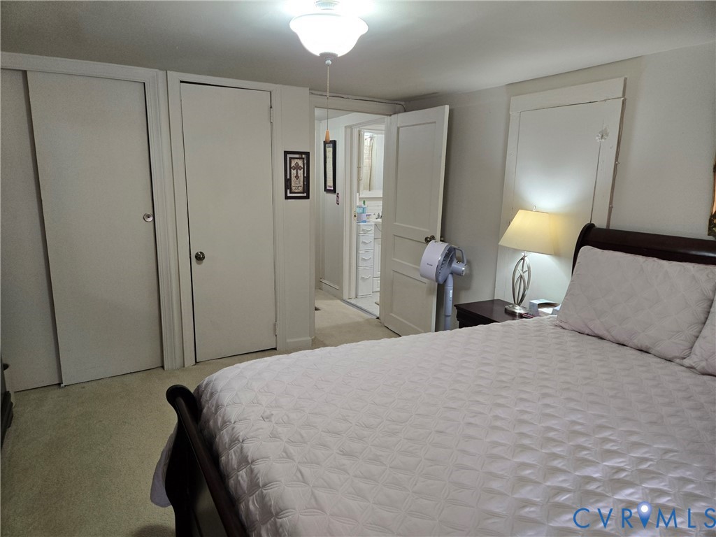 6883 Flat Rock Road Warfield, VA 23889 - Photo 15 of 25 a bedroom with a bed and a lamp