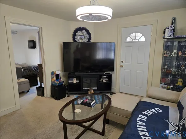 a living room with furniture a rug and a flat screen tv