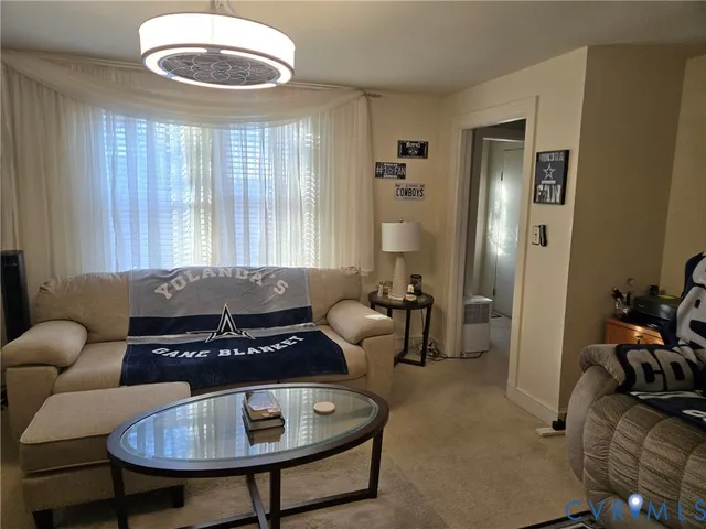 a view of a livingroom with furniture and window