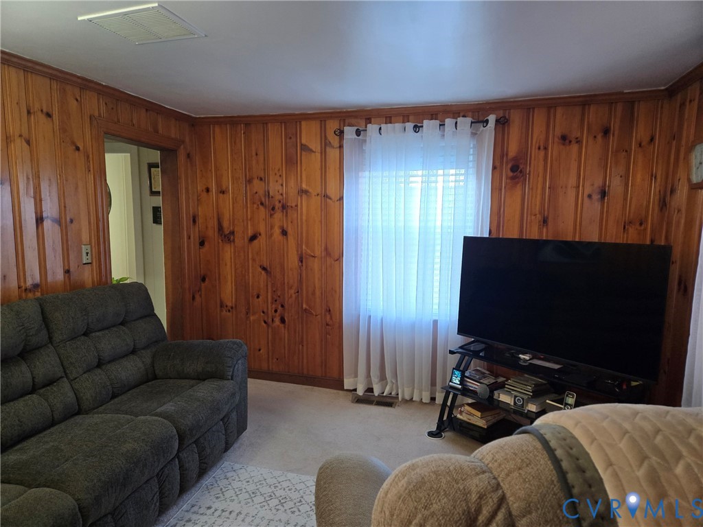 6883 Flat Rock Road Warfield, VA 23889 - Photo 4 of 25 a livingroom with furniture and a flat screen tv