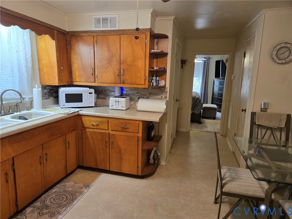 6883 Flat Rock Road Warfield, VA 23889 - Photo 7 of 25 a en suite bathroom with a double vanity sink a mirror and a bathtub