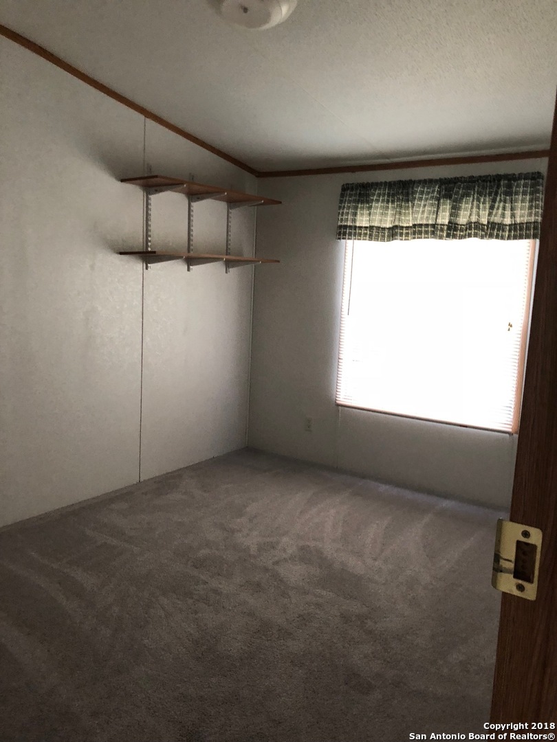 403 Los Indios Road Boerne, TX 78006 - Photo 16 of 21 a view of an empty room with a window