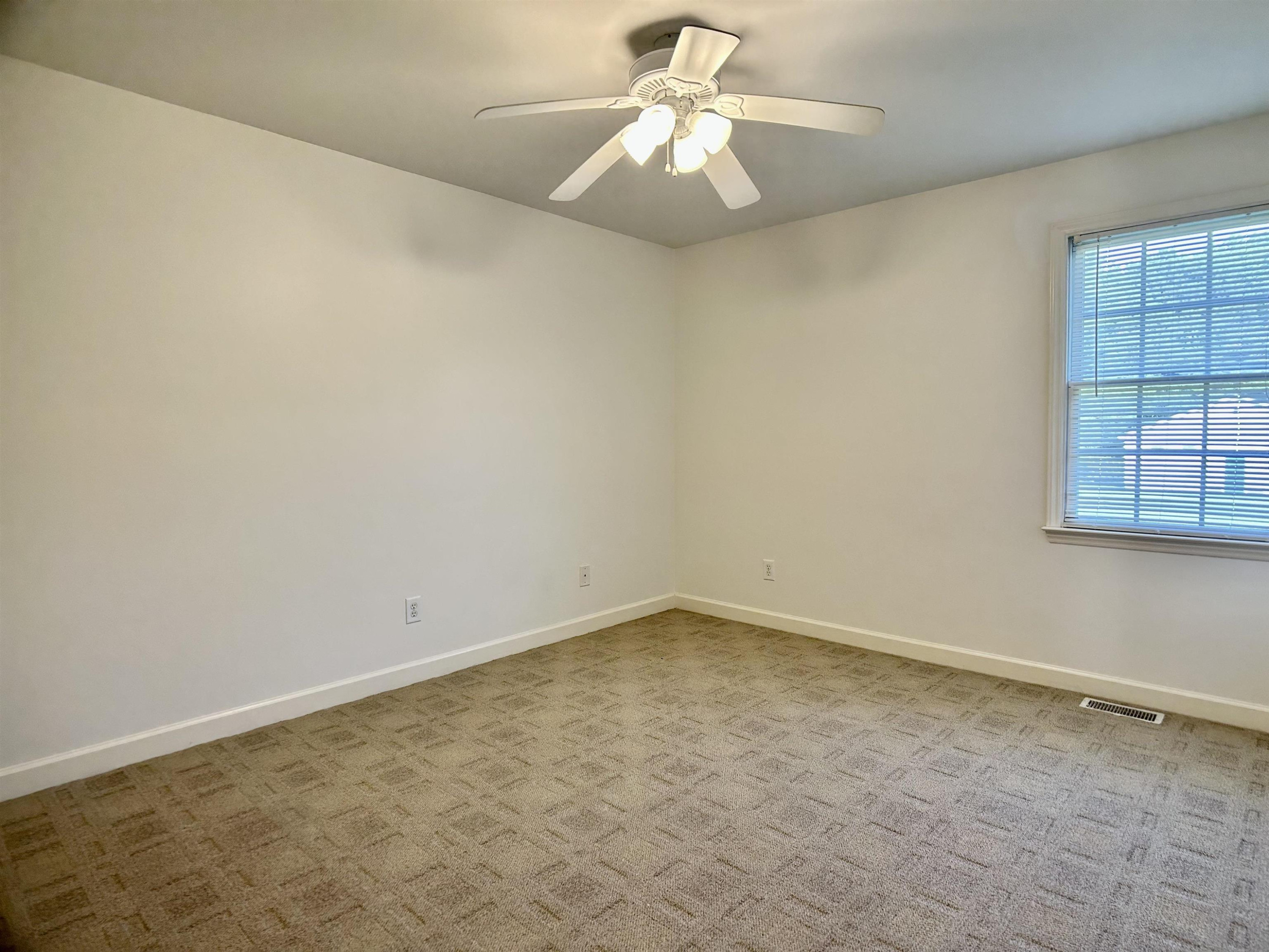 1931 Ranch Road Clayton, NC 27520 - Photo 17 of 34 an empty room with windows and fan