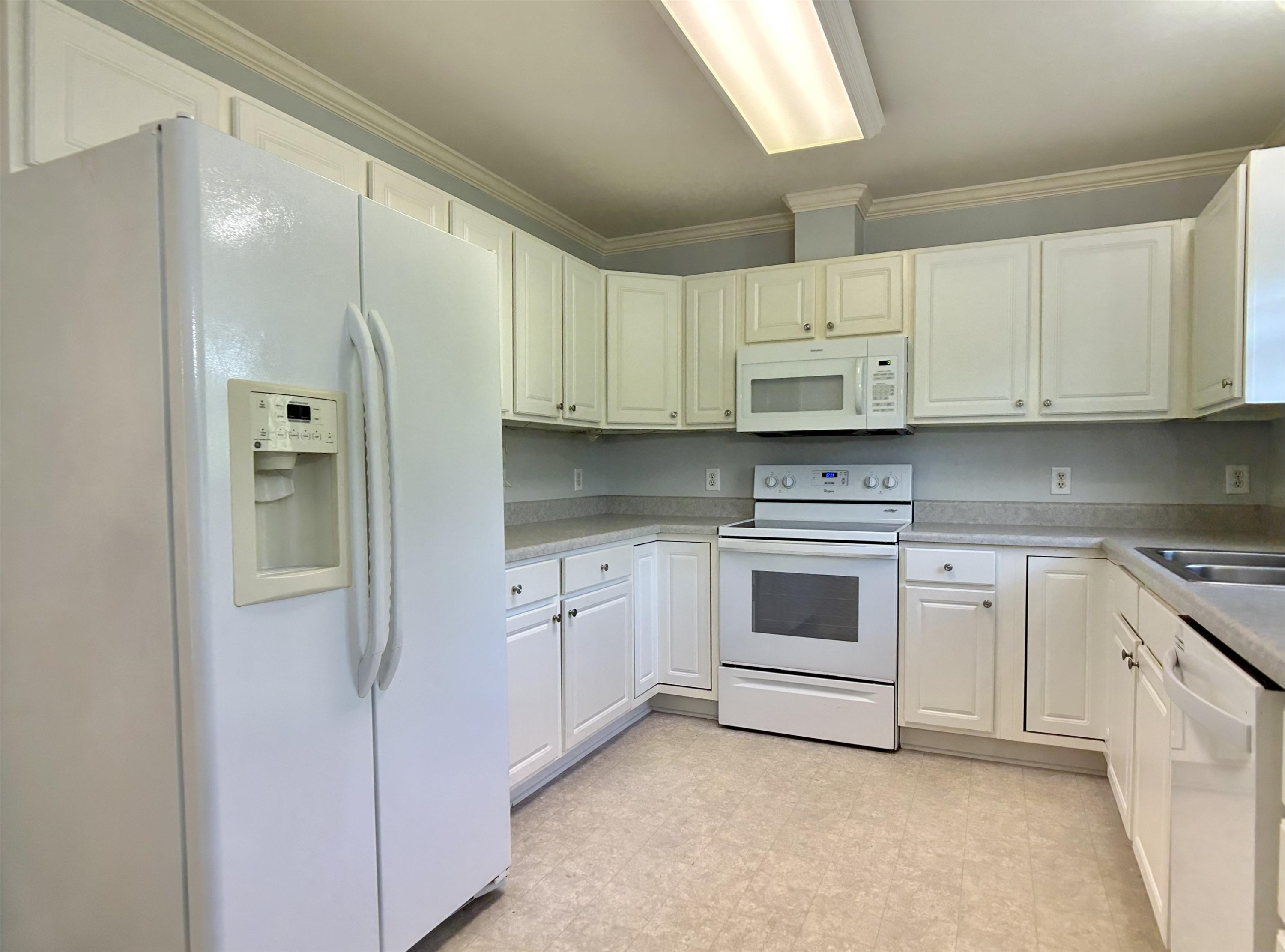 1931 Ranch Road Clayton, NC 27520 - Photo 7 of 34 a kitchen with stainless steel appliances granite countertop white cabinets and refrigerator