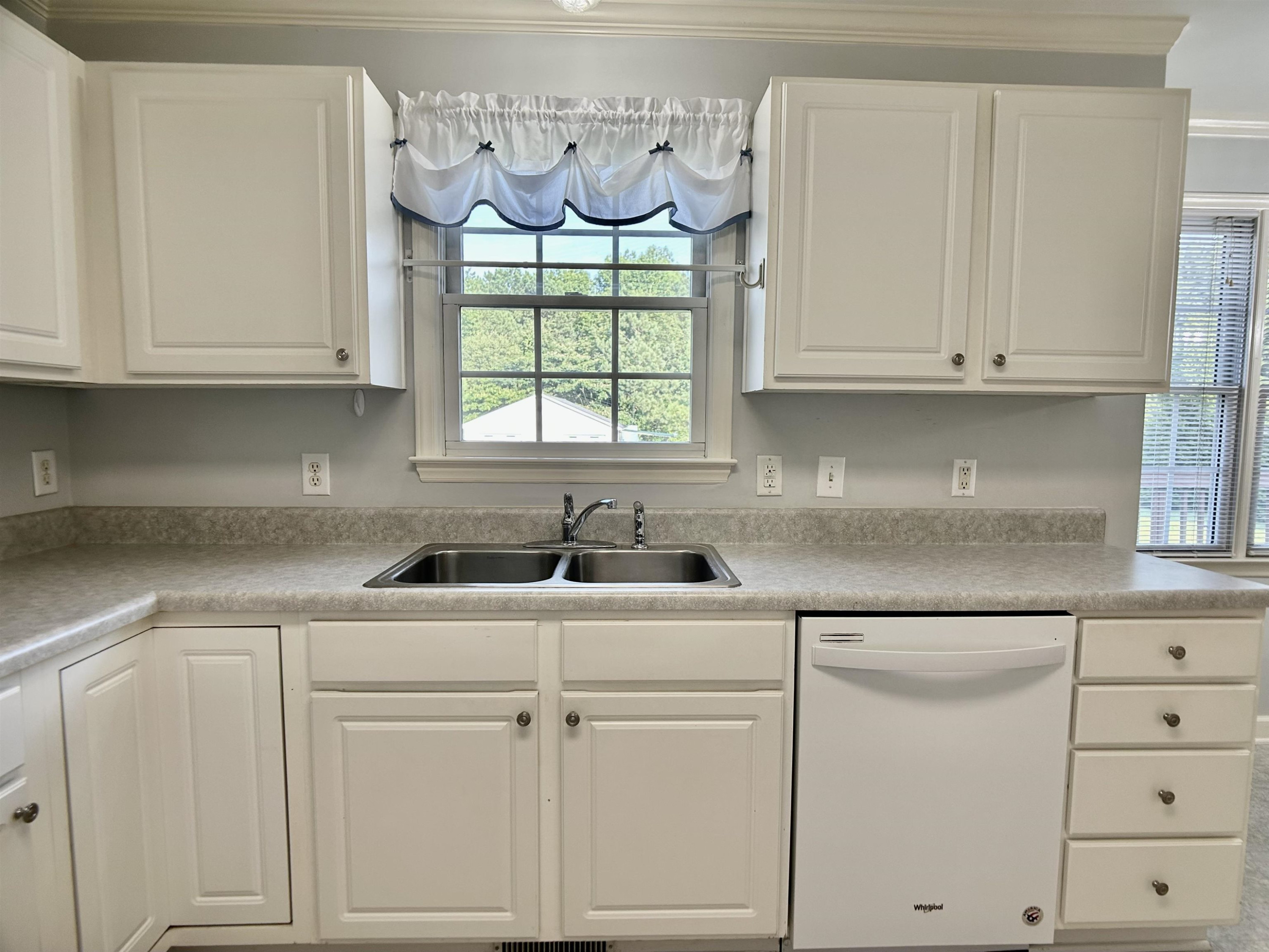 1931 Ranch Road Clayton, NC 27520 - Photo 8 of 34 a kitchen with white cabinets and window