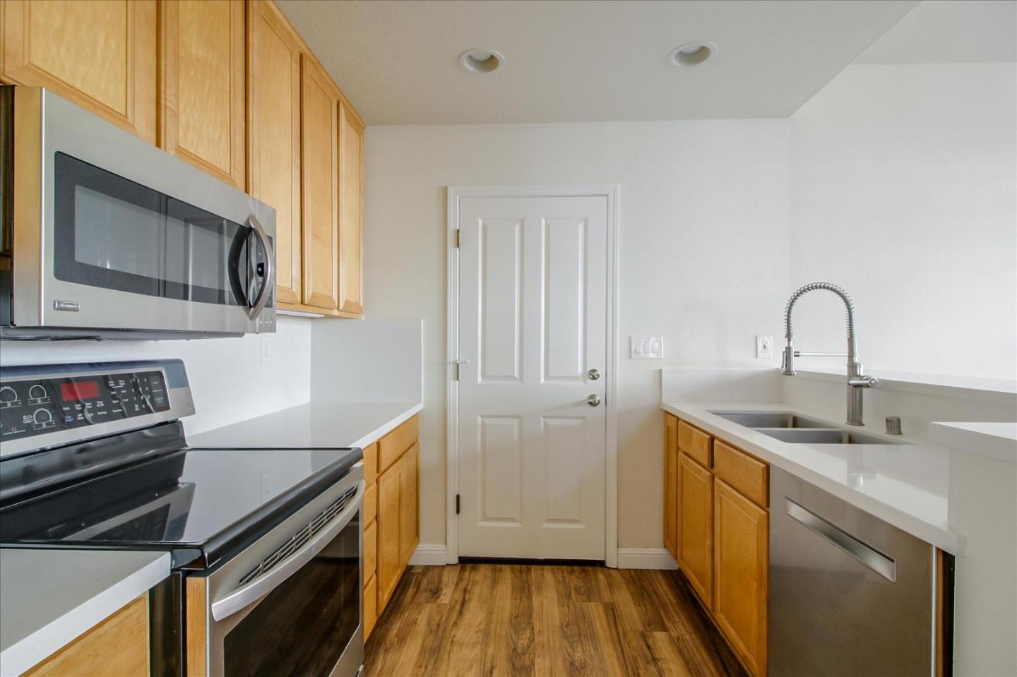 82 Cannery Circle Campbell, CA 95008 - Photo 12 of 35 a kitchen with a sink cabinets and stainless steel appliances