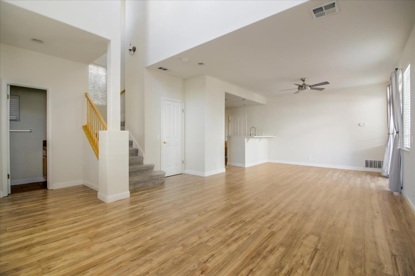 82 Cannery Circle Campbell, CA 95008 - Photo 4 of 35 a view of a livingroom with wooden floor and a ceiling fan
