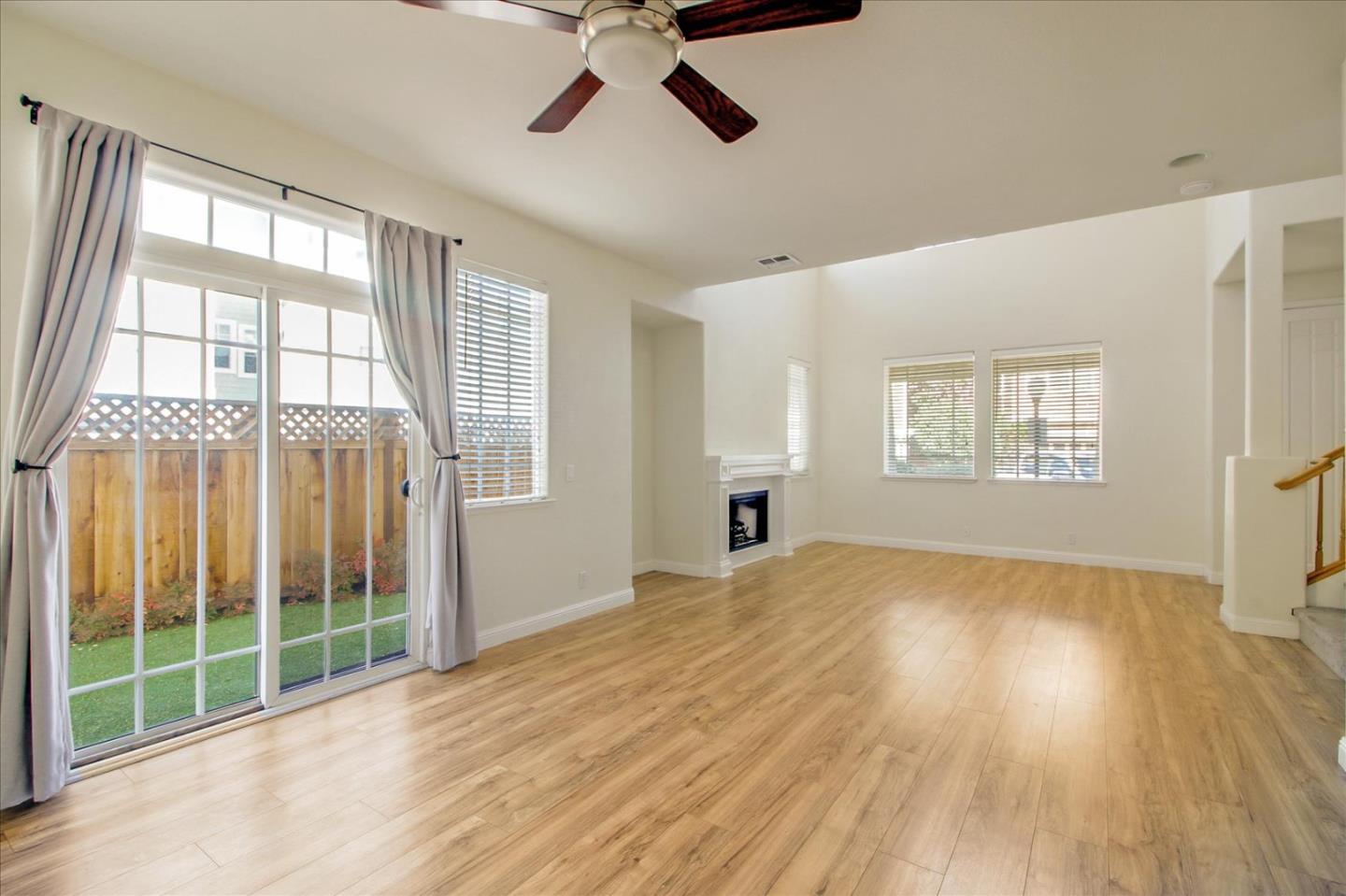 82 Cannery Circle Campbell, CA 95008 - Photo 7 of 35 a view of an empty room with a window and wooden floor