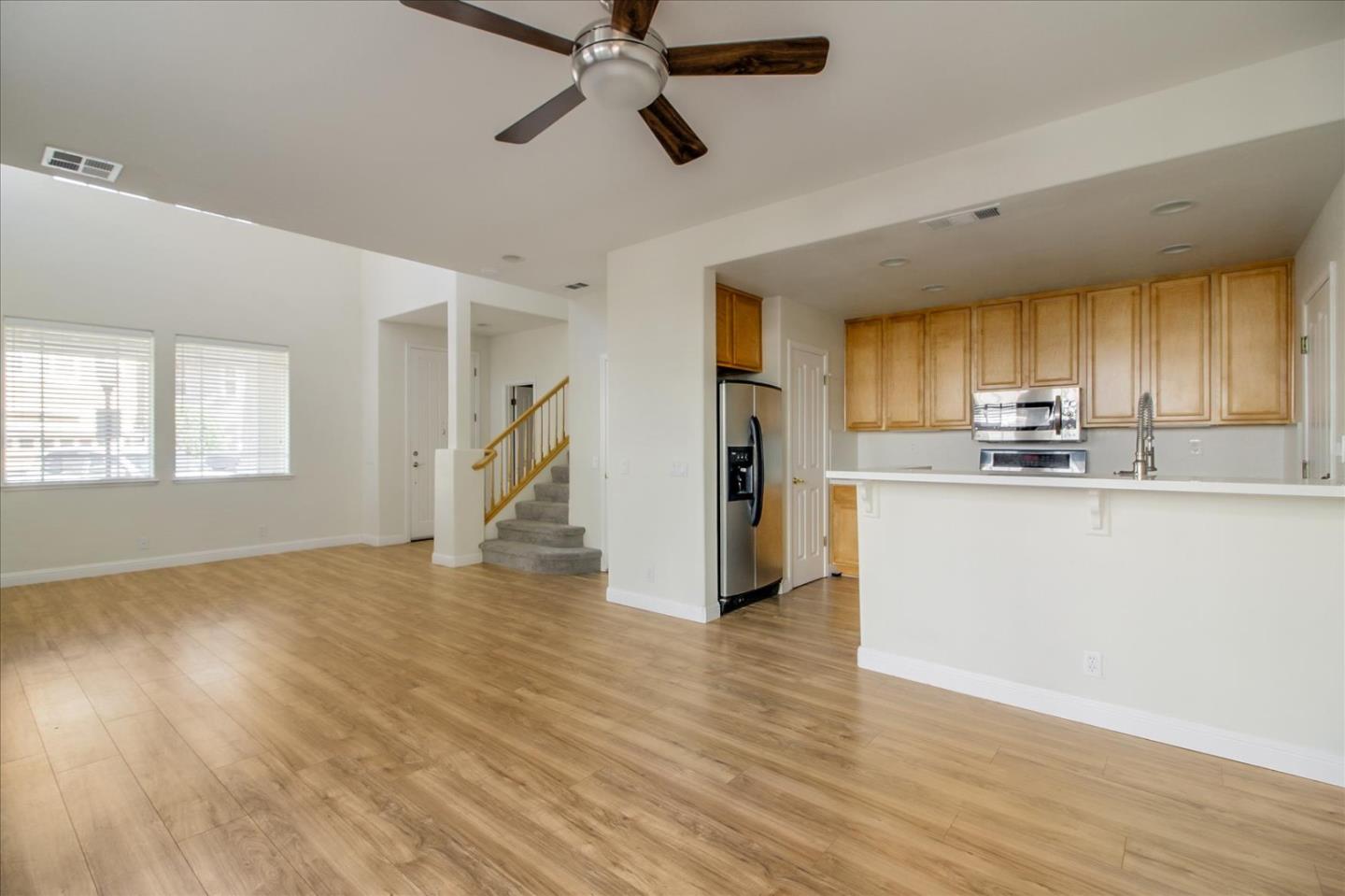 82 Cannery Circle Campbell, CA 95008 - Photo 10 of 35 a kitchen with stainless steel appliances granite countertop a refrigerator a stove top oven a sink and dishwasher with wooden floor