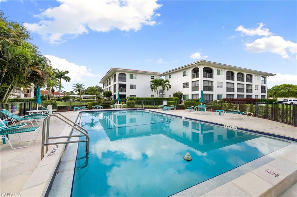 5 High Point Circle West, Unit 307 Naples, FL 34103 - Photo 26 of 31 Community pool with a patio