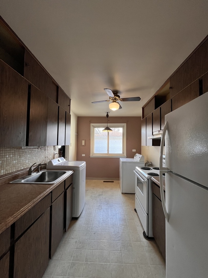 17218 Park Avenue Lansing, IL 60438 - Photo 4 of 19 a kitchen with stainless steel appliances granite countertop a sink stove and refrigerator