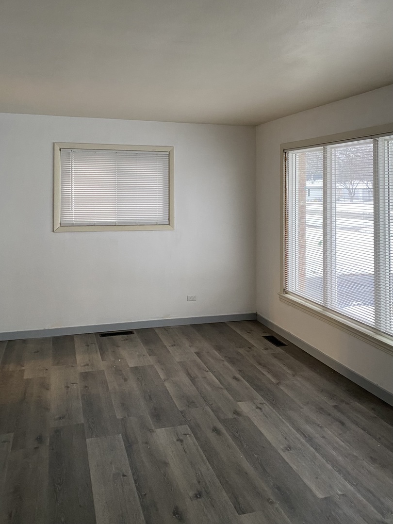 17218 Park Avenue Lansing, IL 60438 - Photo 8 of 19 an empty room with wooden floor and windows