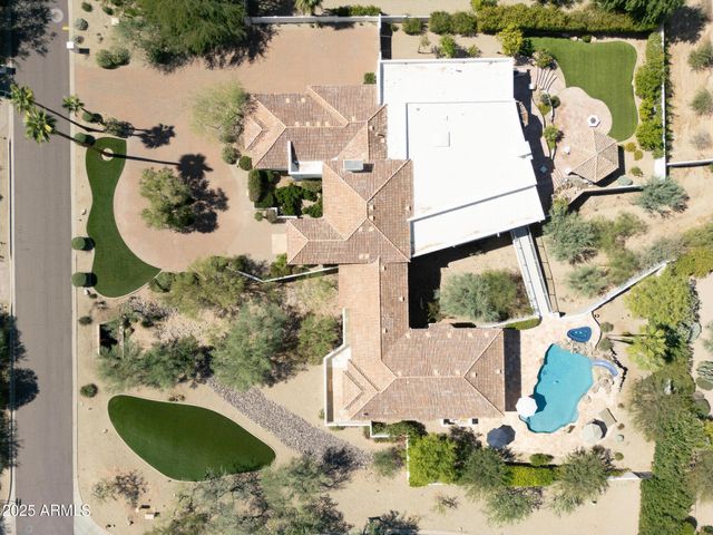 an aerial view of a house with a swimming pool