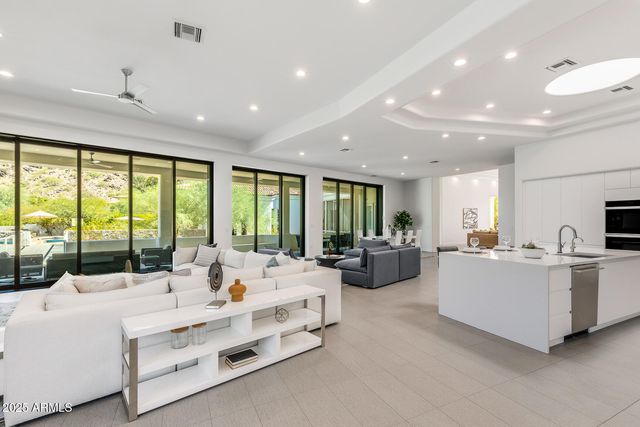 a view of a patio with table and chairs and potted plants