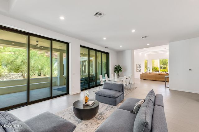 a view of a patio with table and chairs potted plants with palm trees