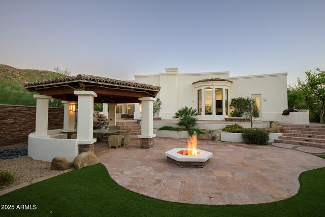 a view of a house with backyard porch and sitting area