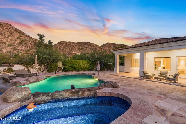 a view of a house with a yard and potted plants