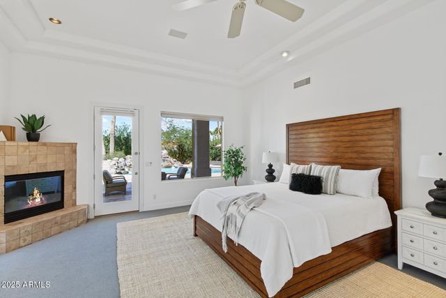 a bedroom with a bed and a chandelier