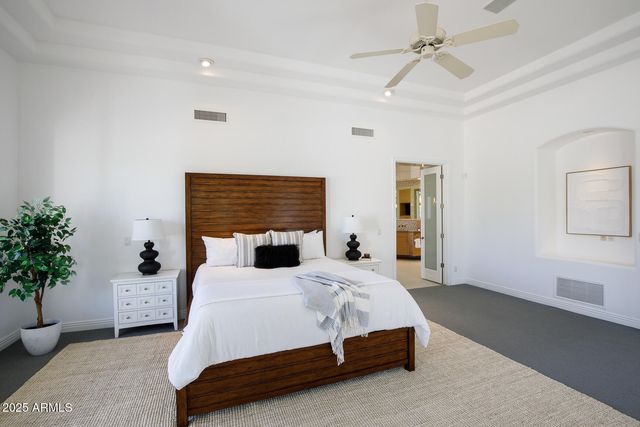 a bedroom with a bed and the view of bathroom