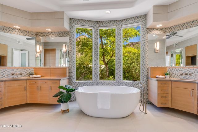 a bathroom with a double vanity sink and mirror
