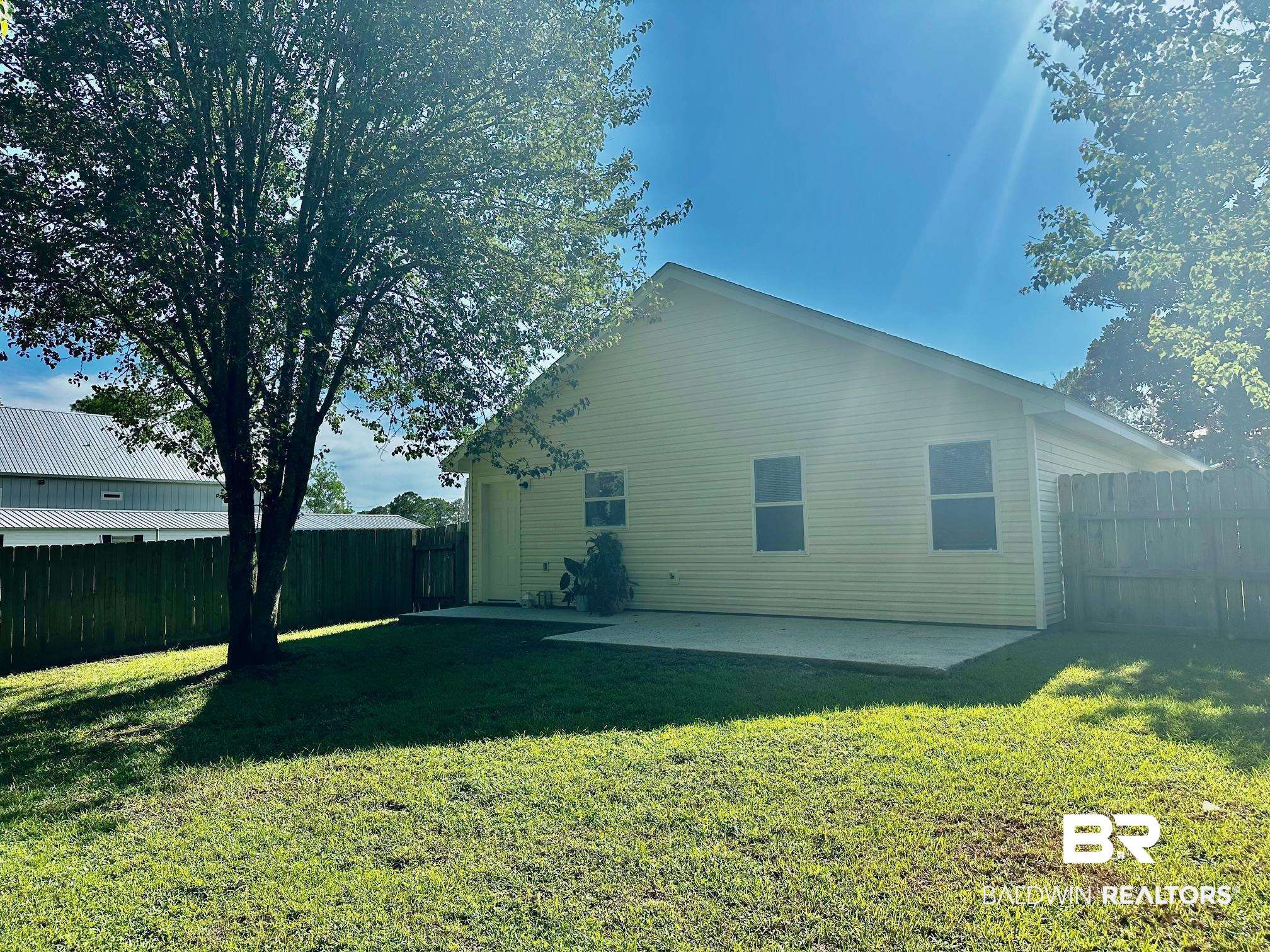 9090 Bay Pnes Road Elberta, AL 36530 - Photo 3 of 26 View of side of property with a yard and a patio area