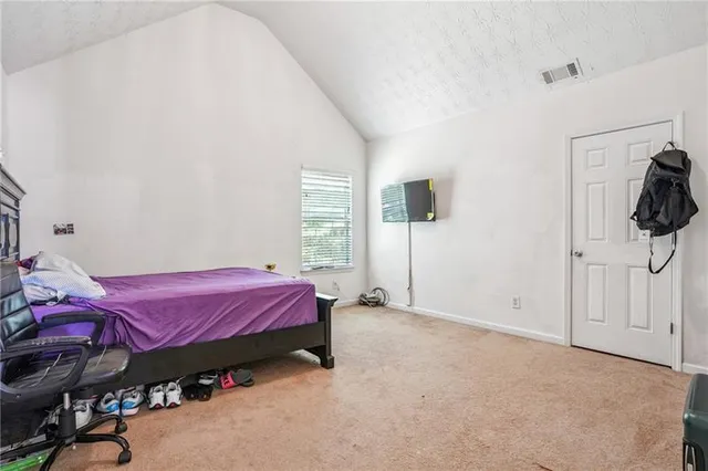 a bed room with a bed and a window