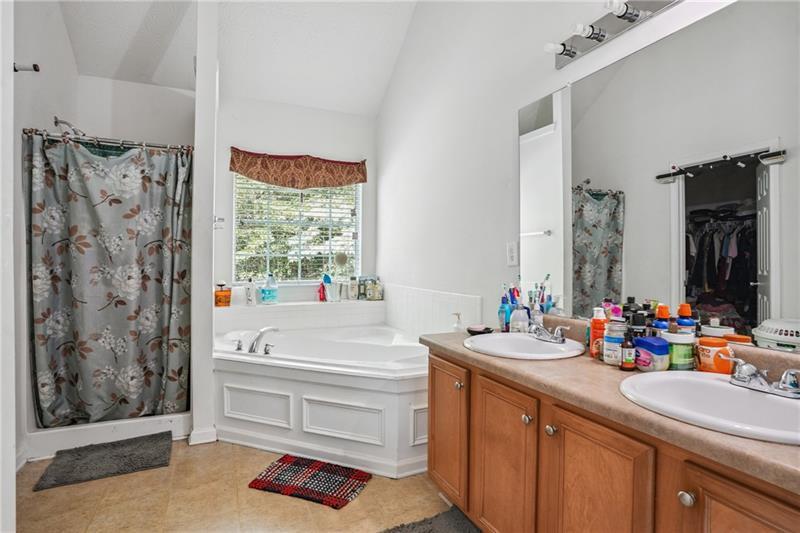 345 Timberlake Terrace Covington, GA 30016 - Photo 7 of 10 a bathroom with a sink mirror and a bathtub