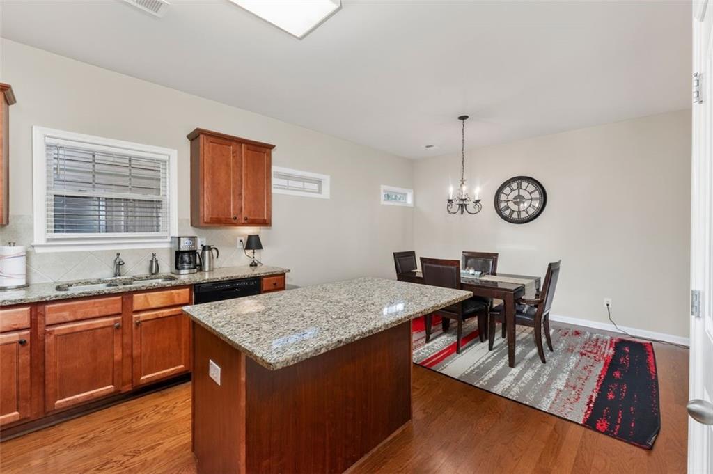 113 Tyson Woods Road Acworth, GA 30102 - Photo 17 of 37 a view of kitchen island with wooden cabinets stove and sink