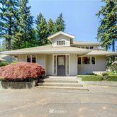 a view of a house with a garden and pathway