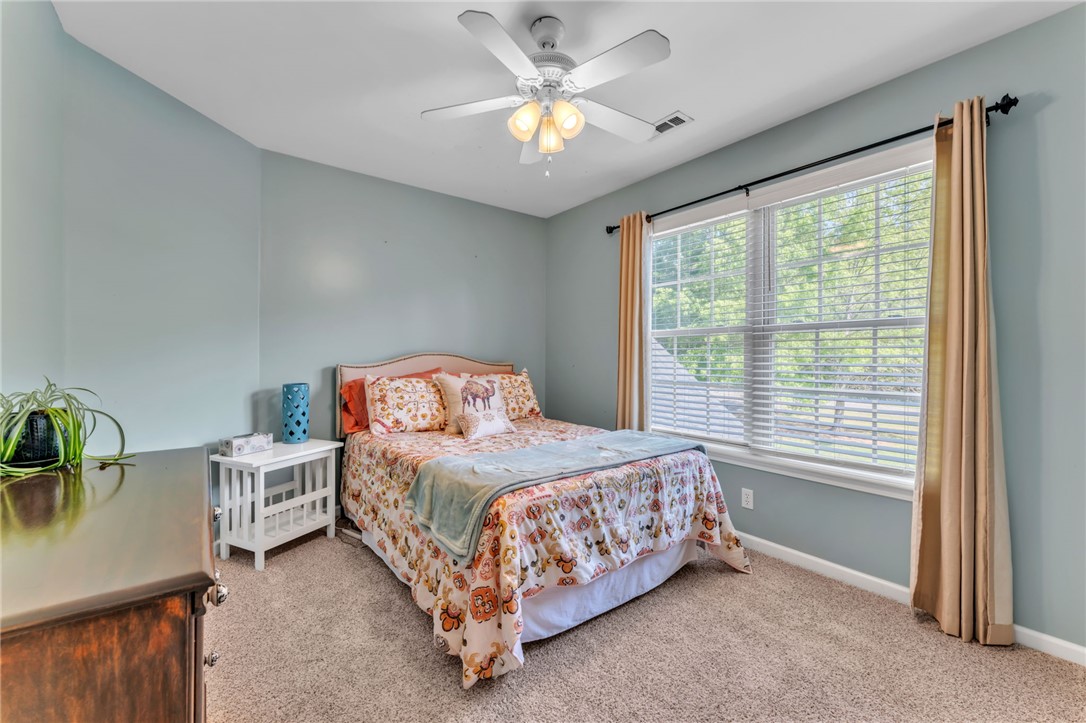 154 Hammond School Road Anderson, SC 29621 - Photo 16 of 33 This cozy bedroom offers comfort and a tranquil escape for residents.