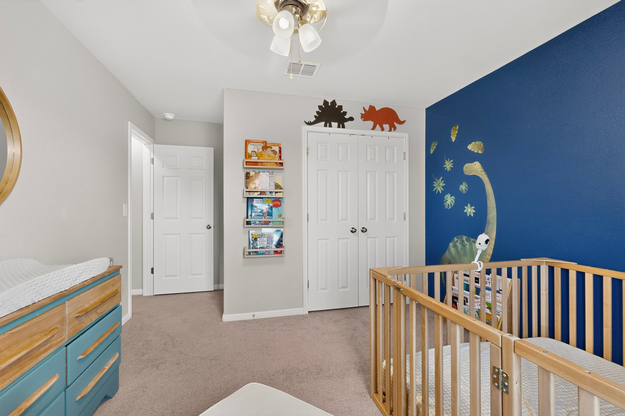 132 Wapiti Road Buda, TX 78610 - Photo 18 of 31 A well-appointed nursery with neutral carpeting and a distinct accent wall.