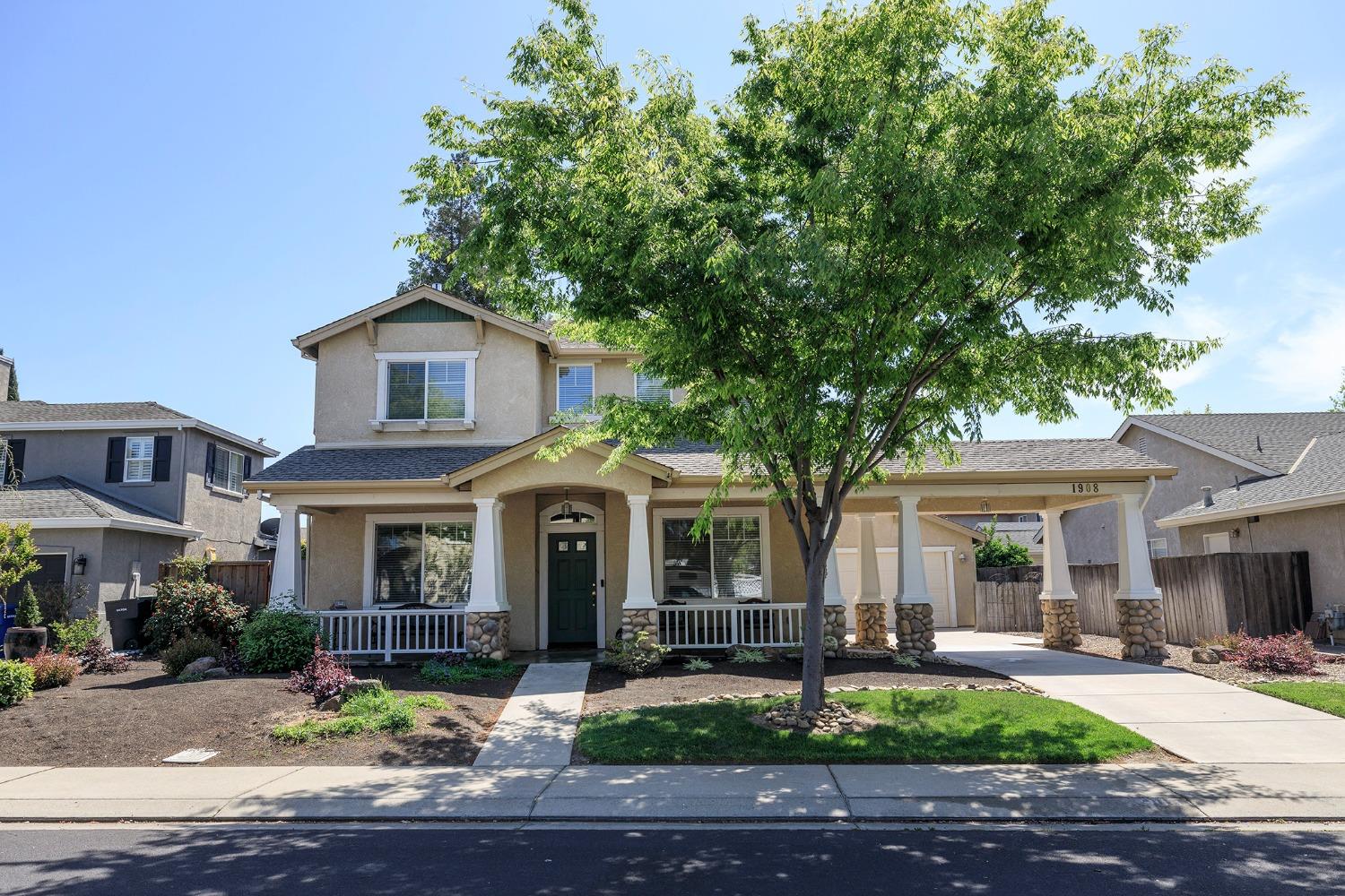 a front view of a house with garden and porch