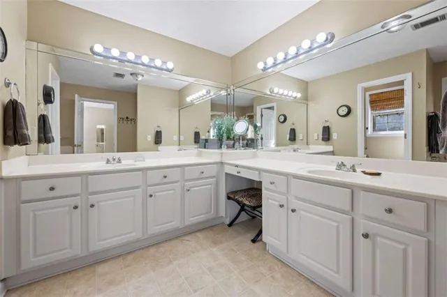 a spacious bathroom with a double vanity sink mirror and