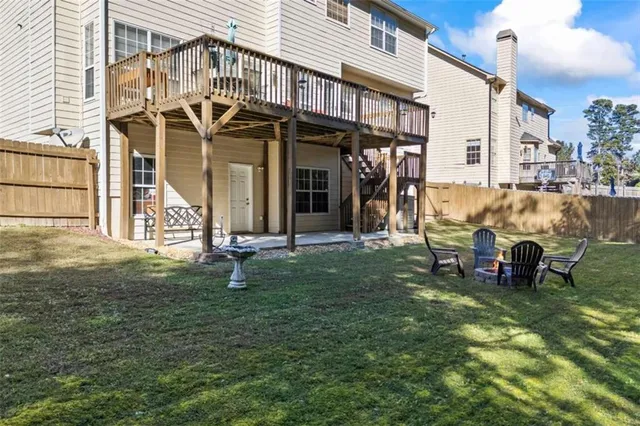 a backyard of a house with yard and outdoor seating