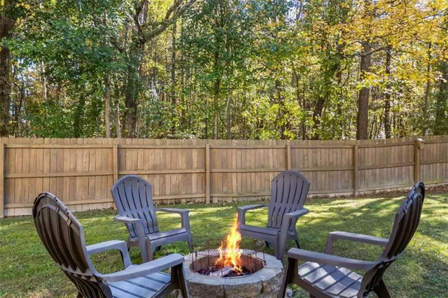 a view of a chairs and table in backyard
