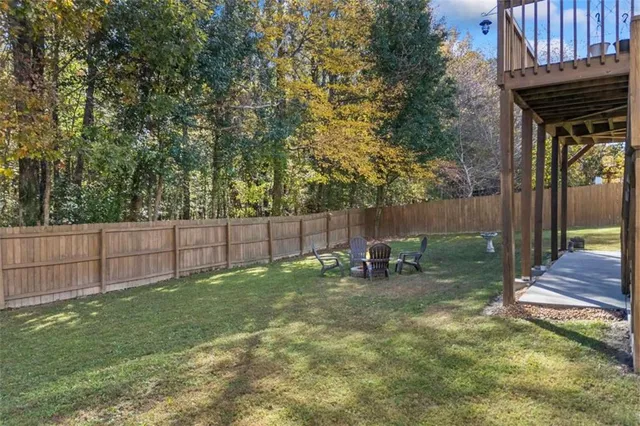 a view of a backyard with a small cabin and a chair