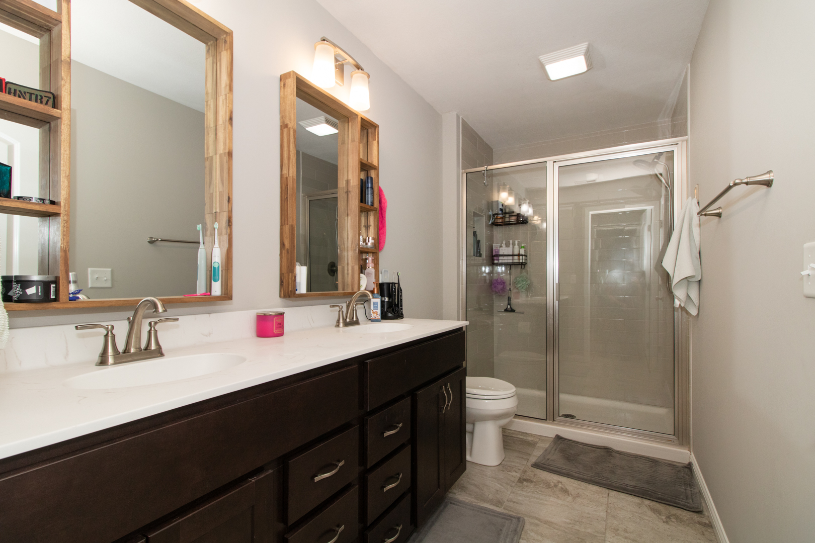 1767 Beech Street Normal, IL 61761 - Photo 41 of 55 a bathroom with a double vanity sink toilet mirror and shower