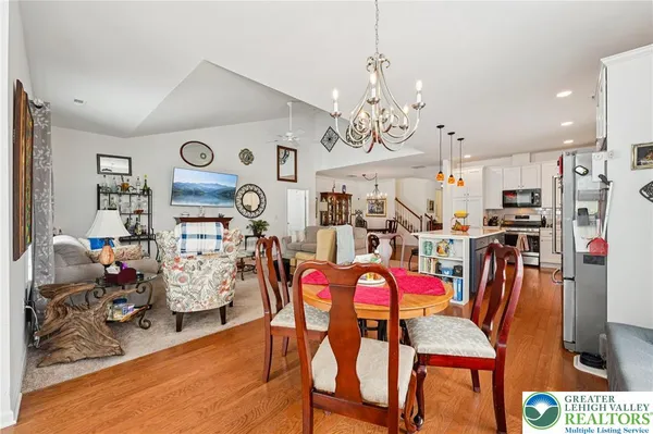 a view of a dining room with furniture and chandelier