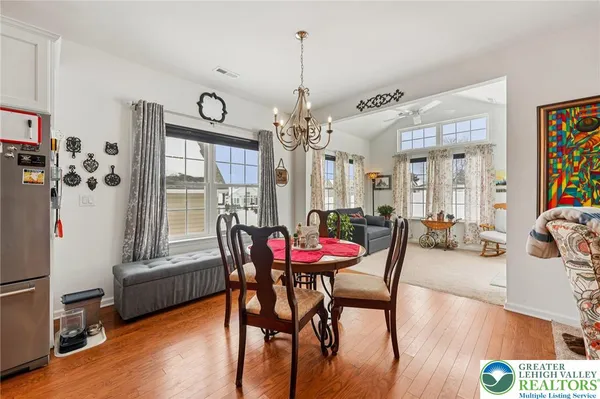 a view of a dining room with furniture and a chandelier