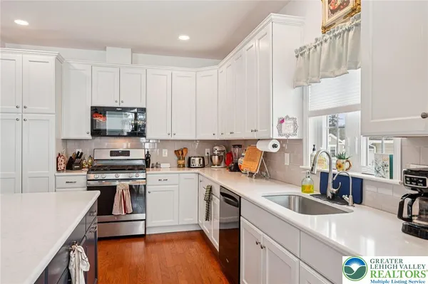 a kitchen with a sink a stove and cabinets